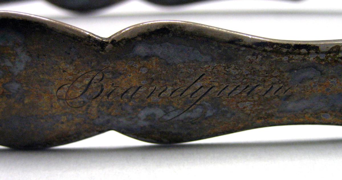 1987.0018 Silver Tongs engraving