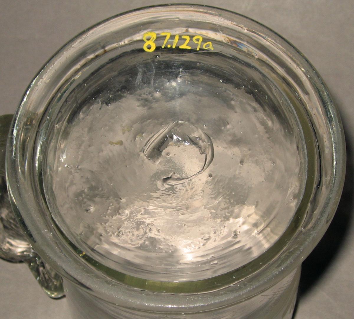 1987.0129 Colorless glass tankard (underside)