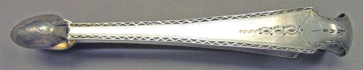 1989.0013.037 Silver Tongs side view