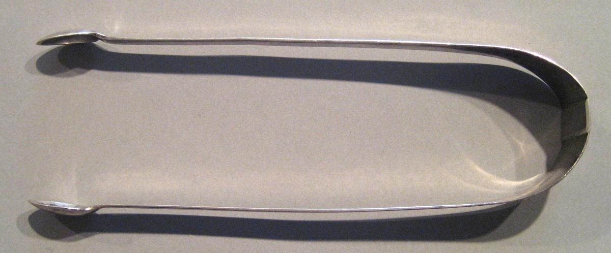 1998.0004.074 Silver Tongs upper surface