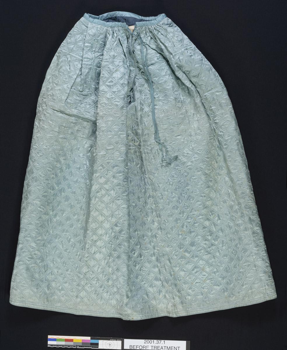 2001.0037.001 Petticoat, back, before conservation treatment