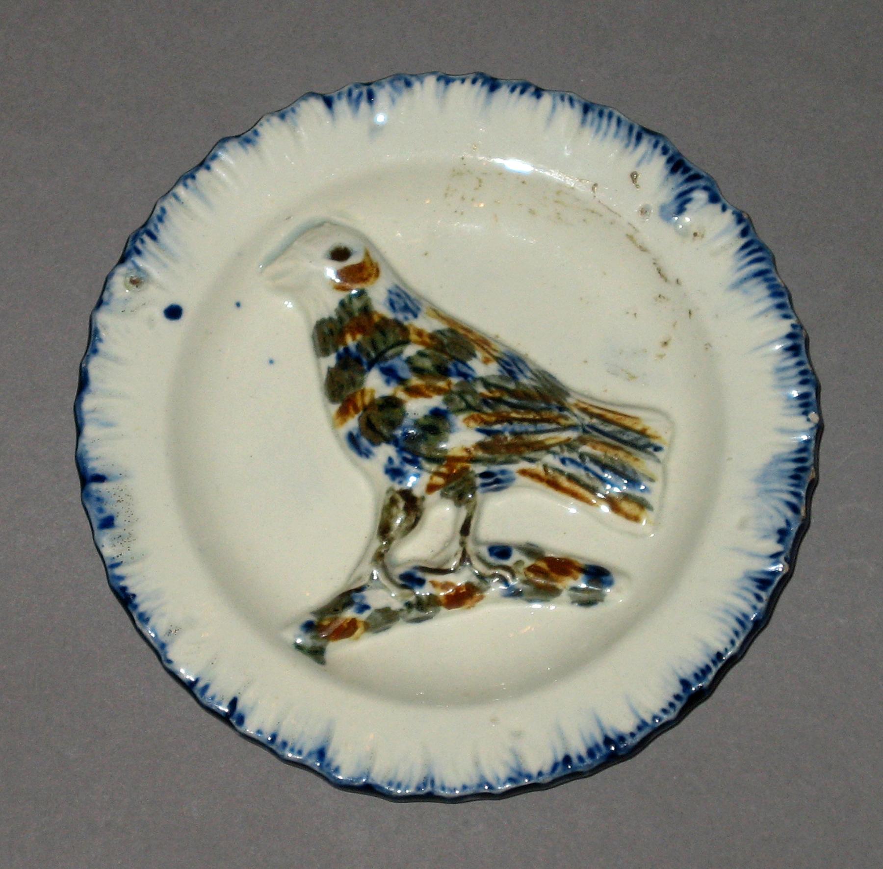2003.0013.135.021 Miniature bird on branch dish