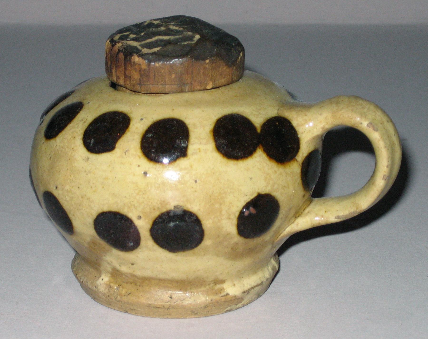 1958.1082 A, B Slipware pot and wood lid