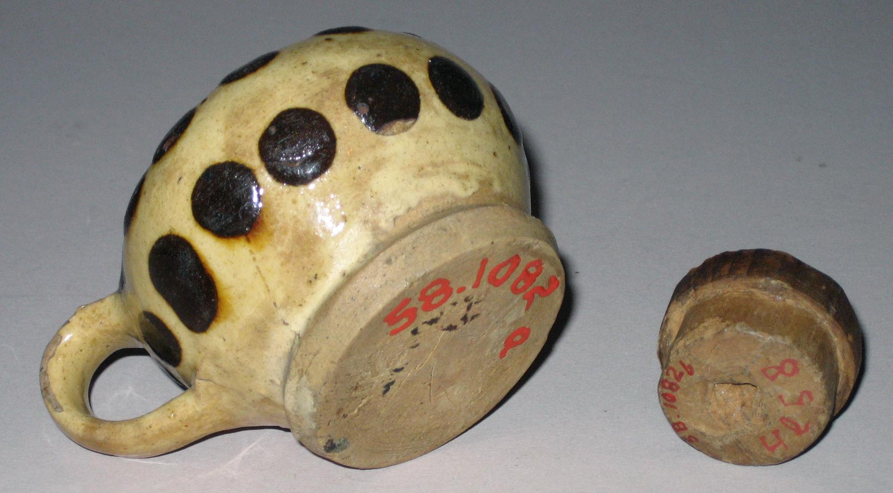 1958.1082 A, B Slipware pot and wood lid (bottom)