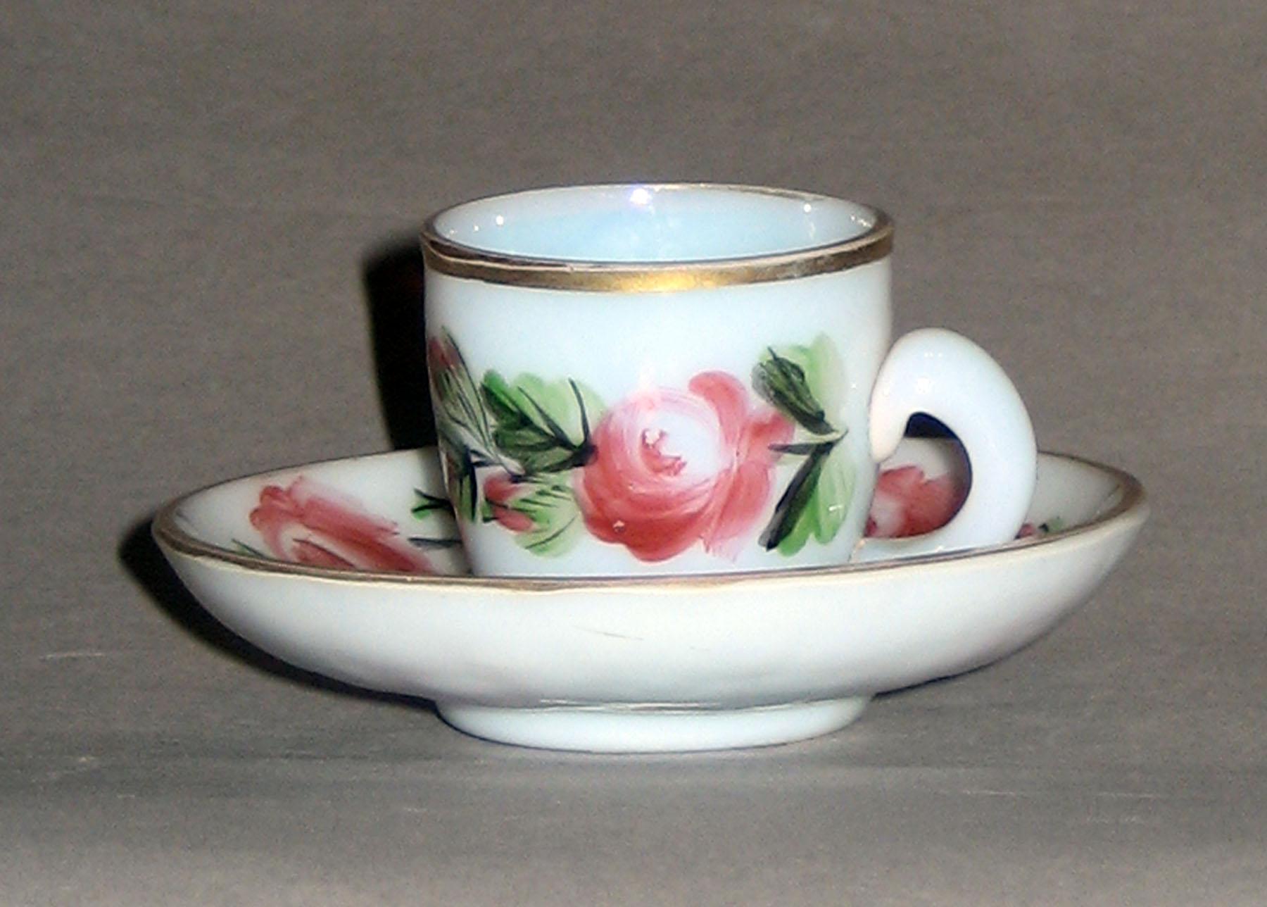 1958.1429.001 A, B White Glass Cup and Saucer