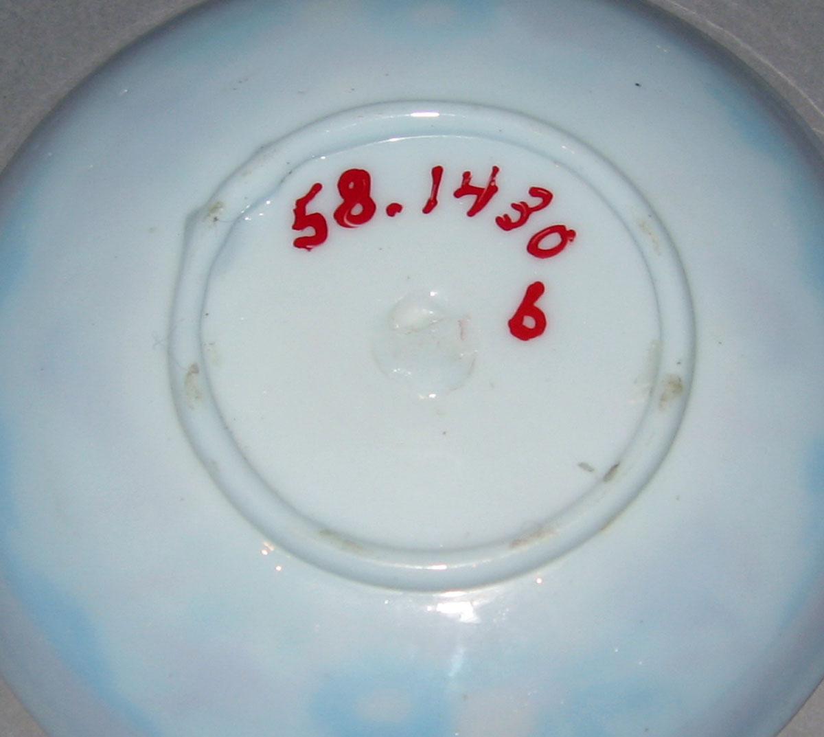 1958.1430 B White glass saucer (underside)