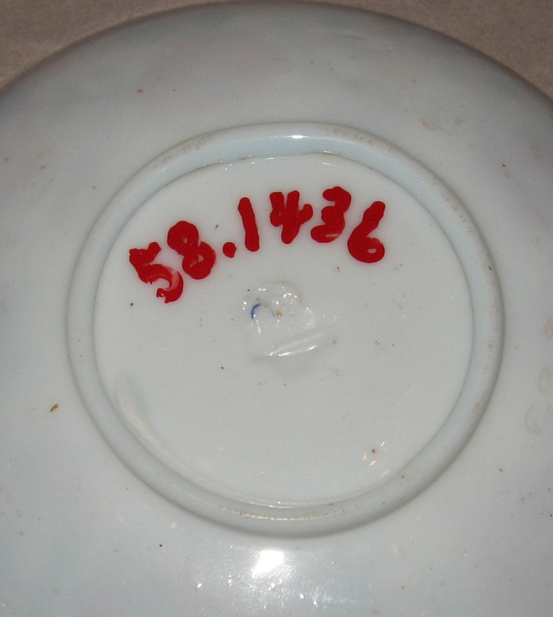 1958.1436 White glass saucer (underside)