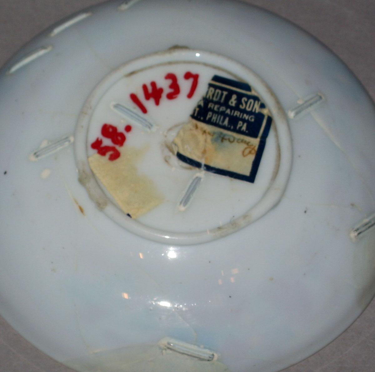 1958.1437 White glass saucer (underside)