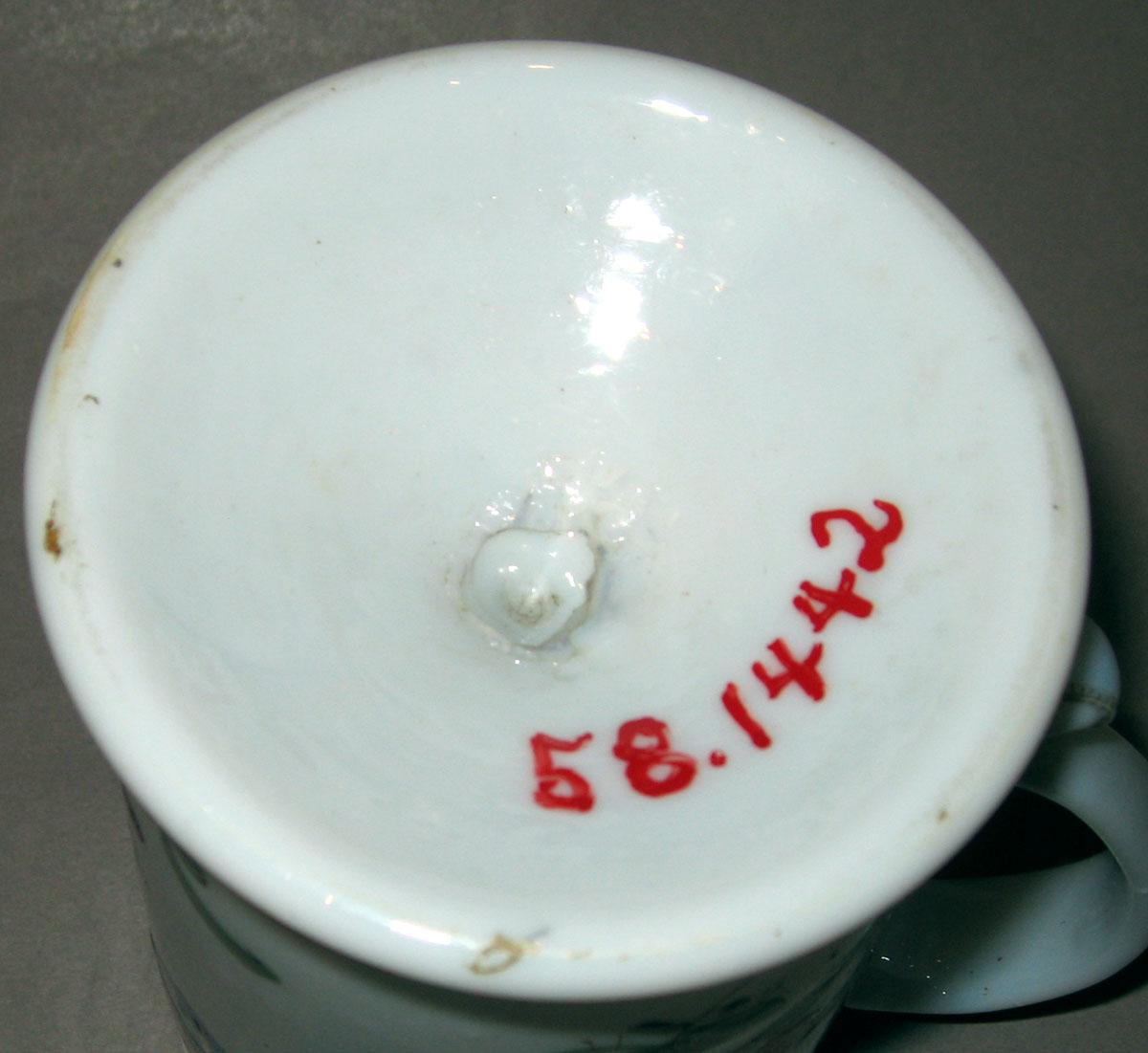 1958.1442 White glass mug (underside)