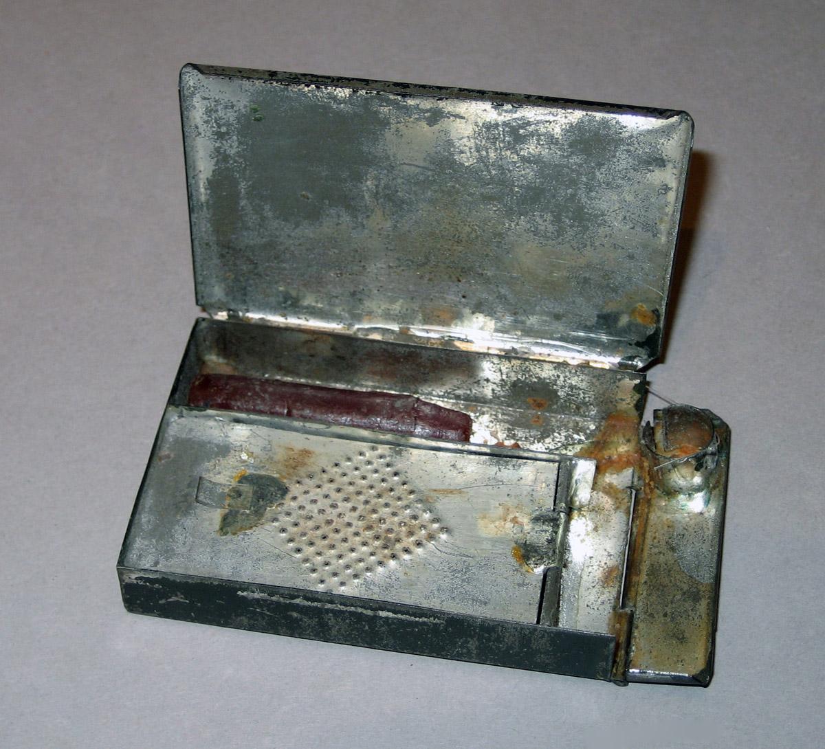 1958.1543 Pocket match and candleholder (inside view)