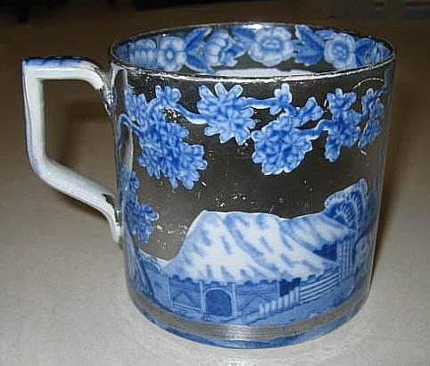 2006.0039.002 Silver lusterware mug (side 2)