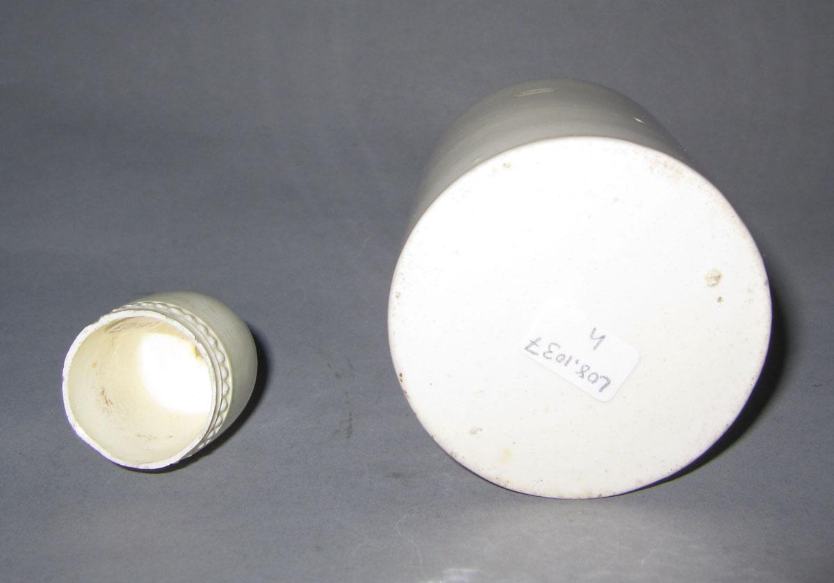 2008.0031 H,I Creamware bottle and lid underside
